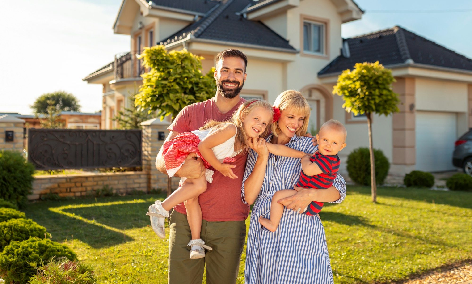 Family standing in front of their new house
